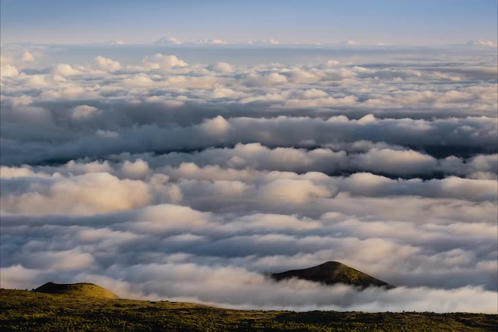 The clouds flow over the mountain