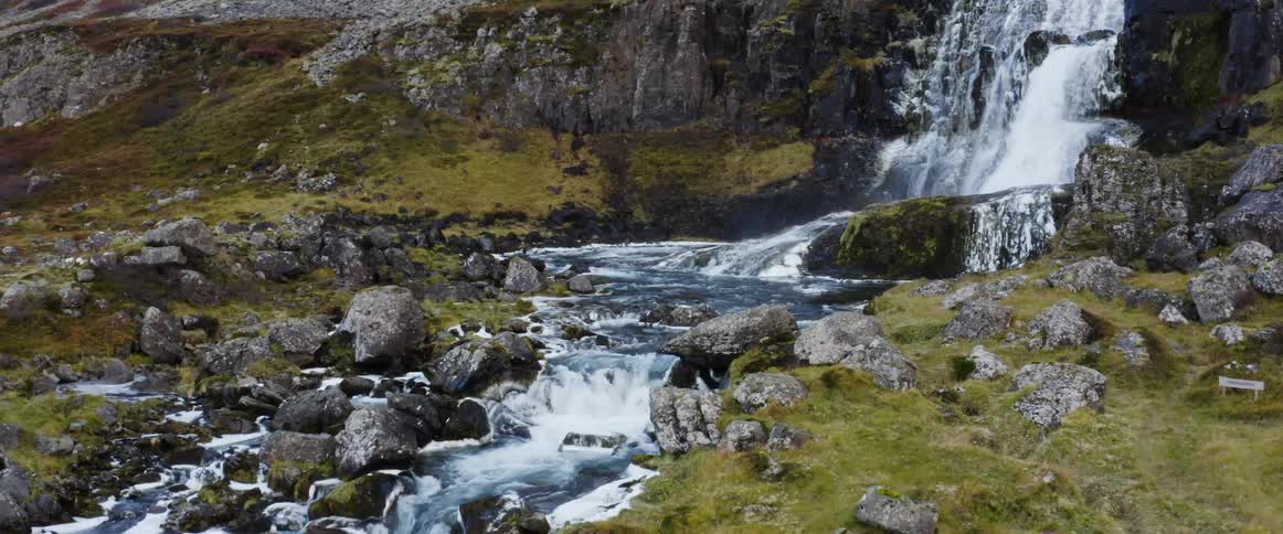 The stream runs down over the rocks