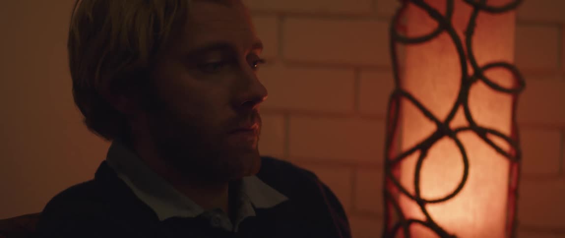 A man sitting in a room thinking