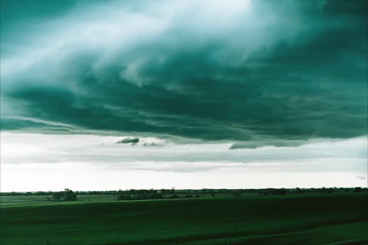 The clouds flow over the field