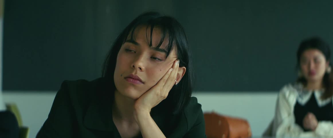 University student sitting on a chair in the classroom listening to the teacher