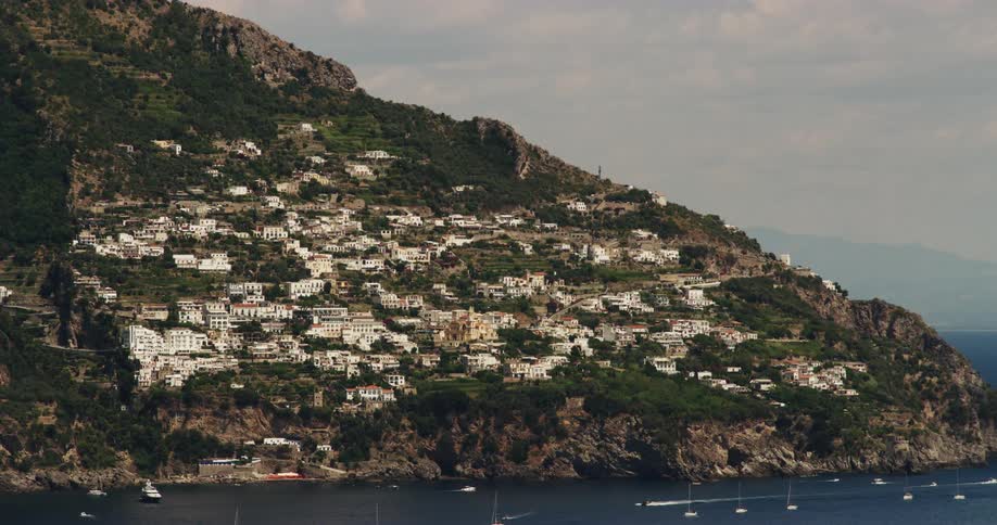 Boats on the sea by a seaside village