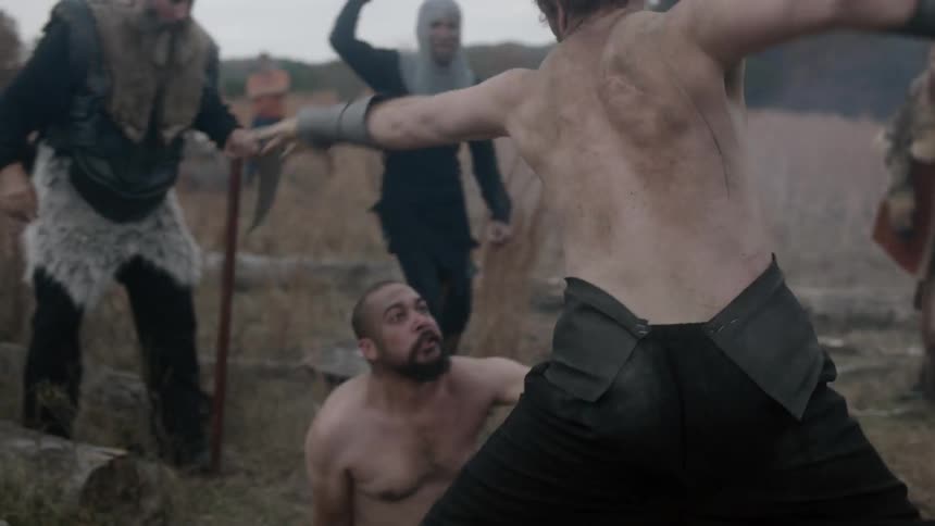Two men fight while others cheer on around them