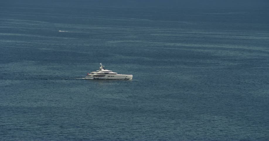 Large yacht slowly moves to the right of the shot