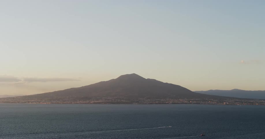 Coastal town built on the slopes of a lonely mountain in the coast at evening