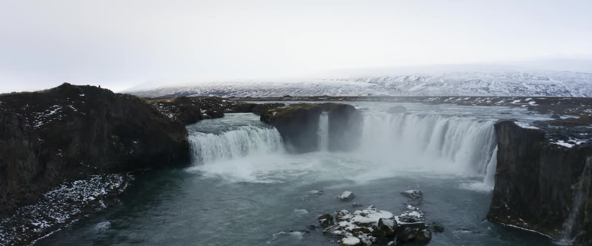 Waterfalls line the cliff