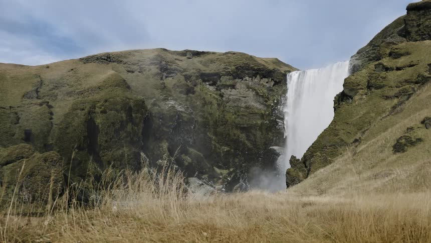 Water is flowing over a cliff in a waterfall
