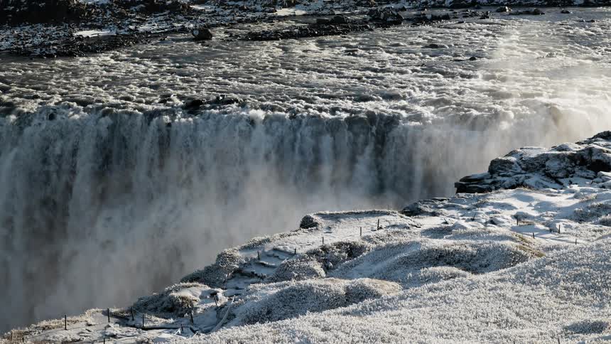 A waterfall flowing over a cliff in winter