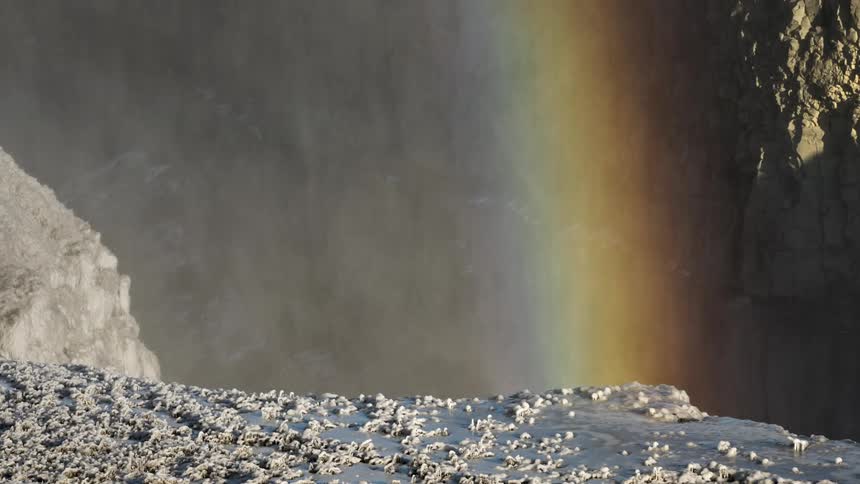 Steam and a rainbow in a canyon