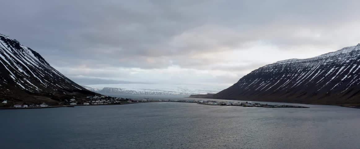 Camera pans over a river between cliffs