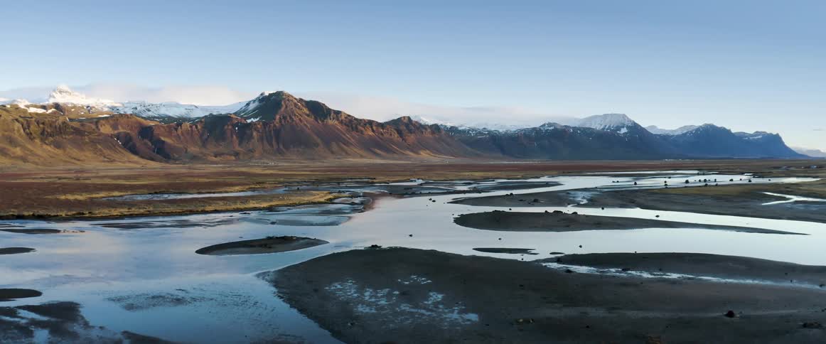 Aerial view of rivers and snowy mountain range