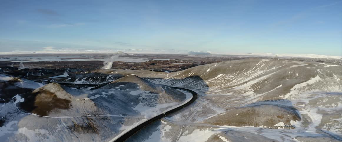 Cars travel on the highway through the mountains