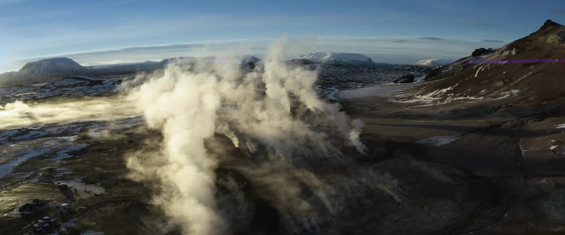 Person moves around near rv parked near fog rising from icy ground between mountains