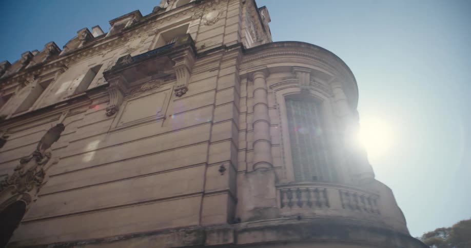 A stone building in a city on a clear sunny day