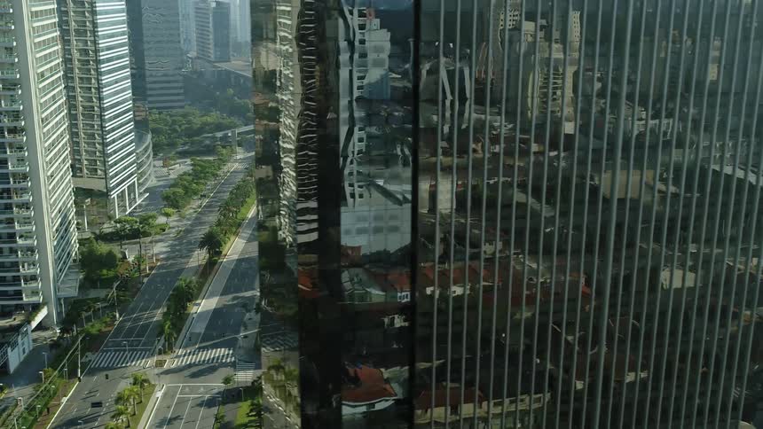 Camera pans past highrise buildings to eventually show a street