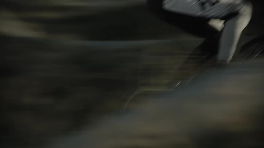 A bmx racer is riding their bike on a hilly course