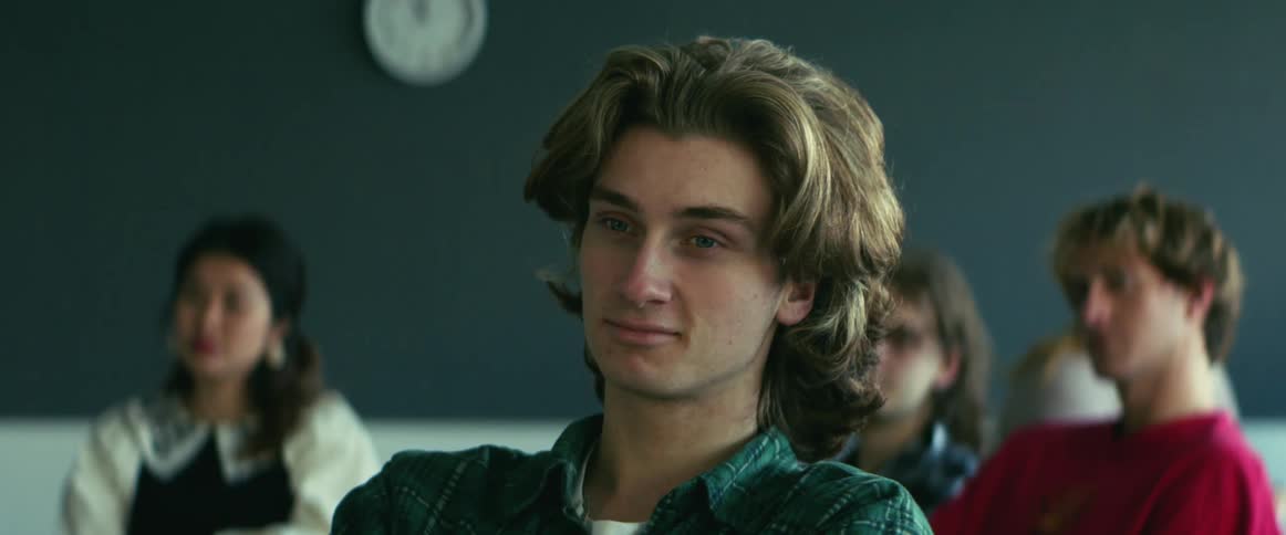University student sitting on a chair in the classroom listening to the teacher
