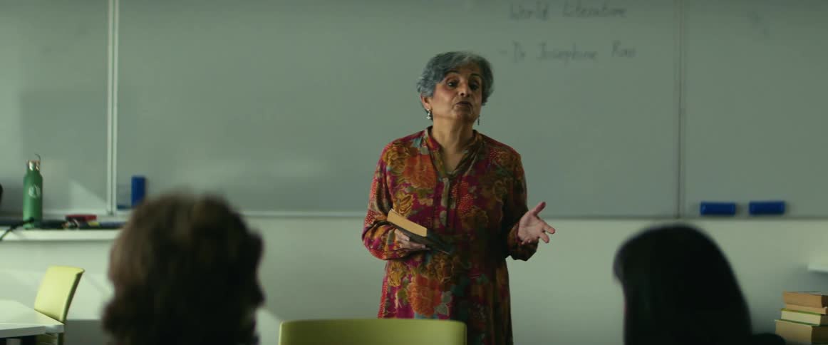 A teacher is giving a lecture to her class