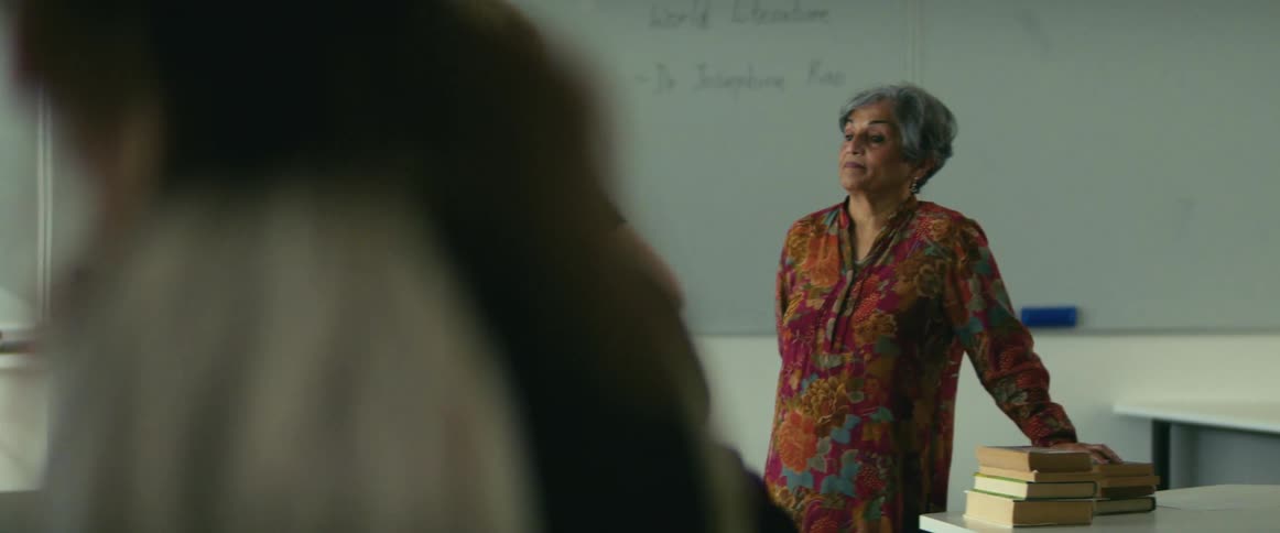 Teacher watches as students leave classroom