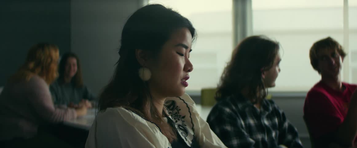 Students sitting at desk wait for lecture to start in classroom