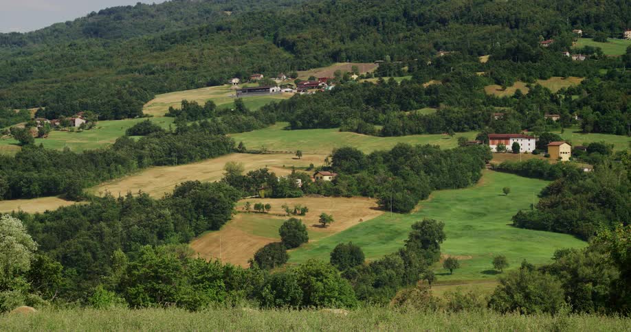 Shot over rural countryside with a smattering of houses