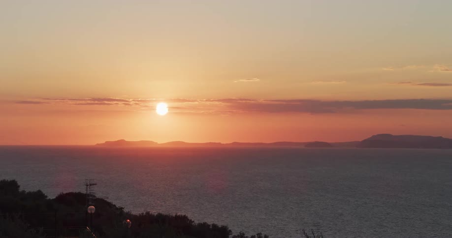 The sun setting over a coastal area