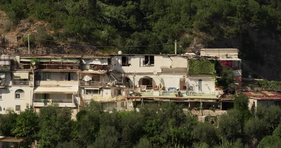 Trees surround a run down building on a mountain