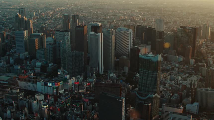 City skyscrapers and building rooftops with sunlight glaring