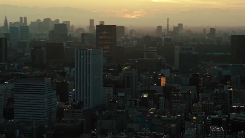 City skyscrapers extend to the horizon under a red sky