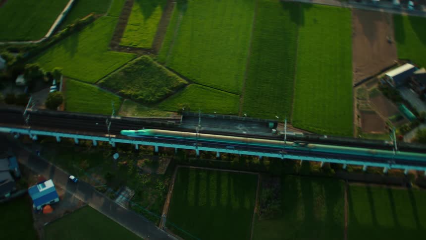 A high speed passenger train passes through a suburb
