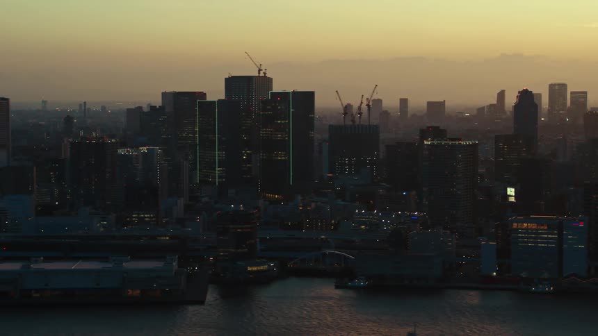 The sun sets through heavy smog over a congested city