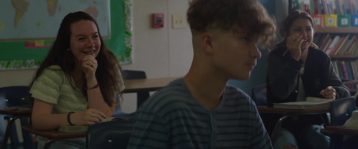 Students laugh while sitting in a classroom