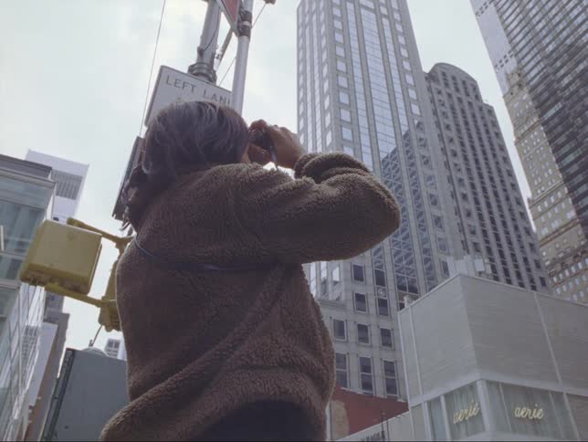 A woman is photographing buildings