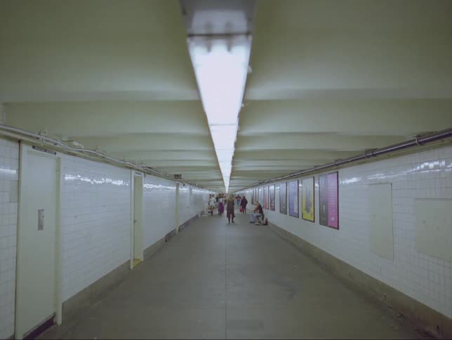 People are walking through the subway tunnel