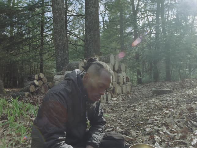 Two men are playing instruments in the woods