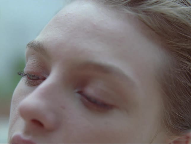 A man runs his hand through the hair of a young woman