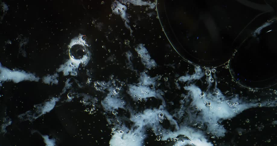 Air bubbles of different sizes on the surface of a semi frozen liquid