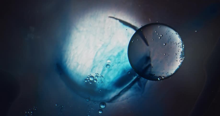 A perfect bubble coated with smaller bubbles floats to the side