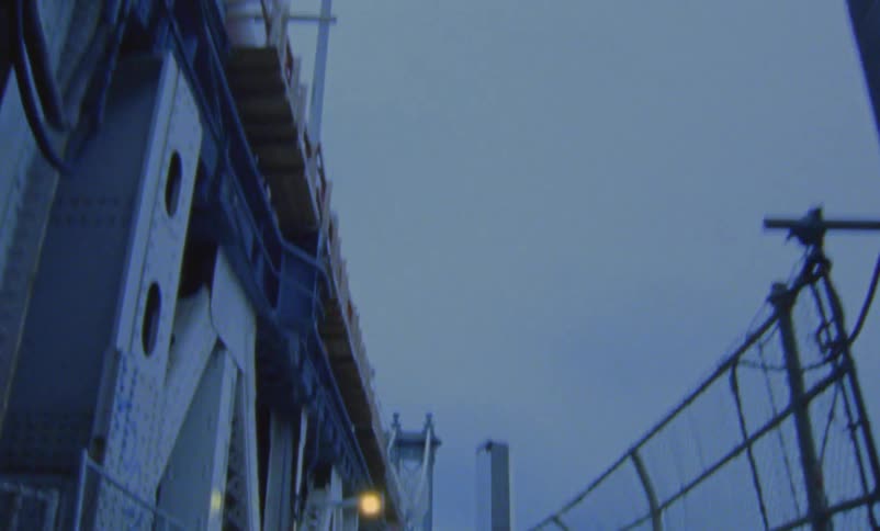 A bridge with a city skyline in the distance