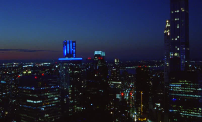 Skyscrapers and city lights in an urban area at dusk