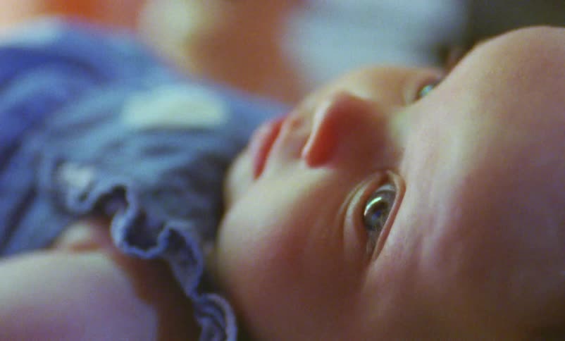 A baby lies on her back