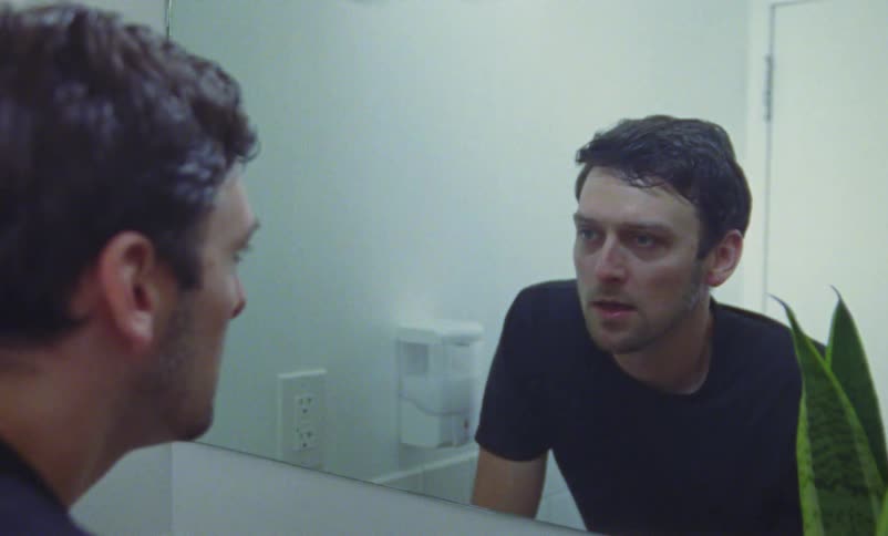 A man washes his face in the sink