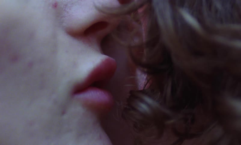 A woman whispers i love you into a mans ear