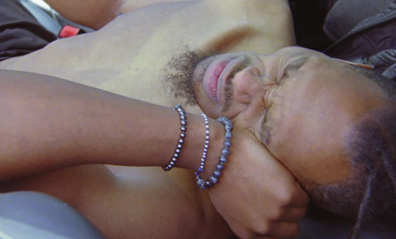 A man is resting in his car during the day time