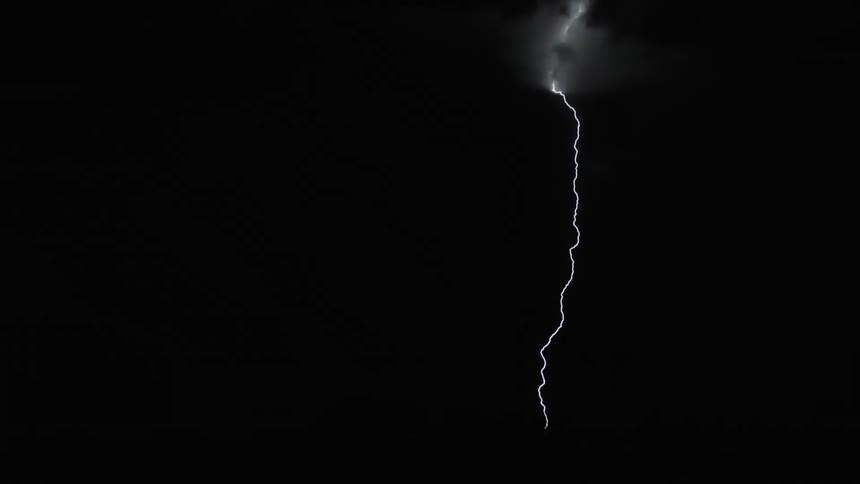 Lightning flashing across a night sky during a storm