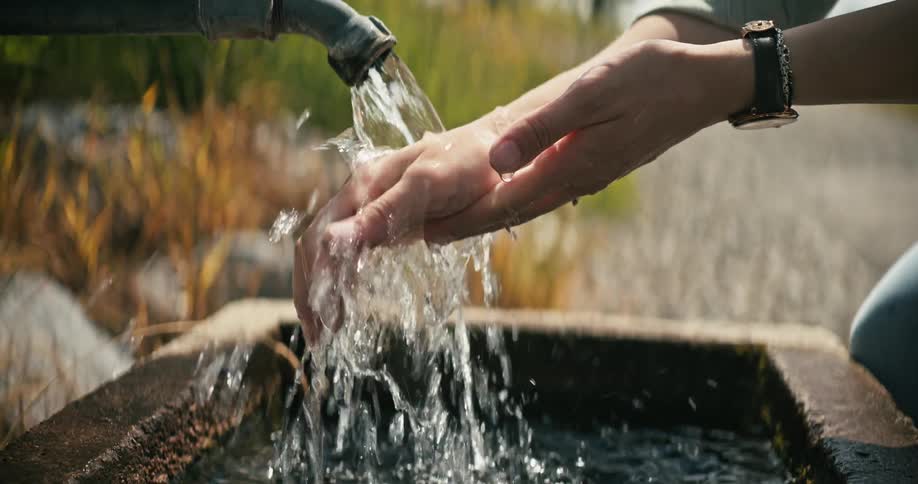 A person is watching their hands outside