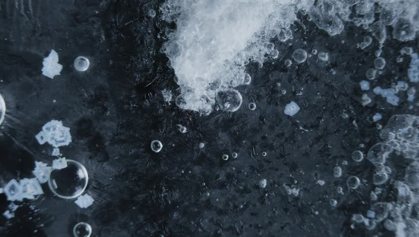 Time lapse close up of water crystals forming on the surface of bubbling water