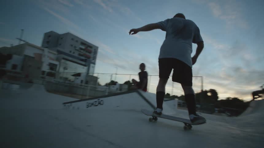 A man riding a skatepark at sunset