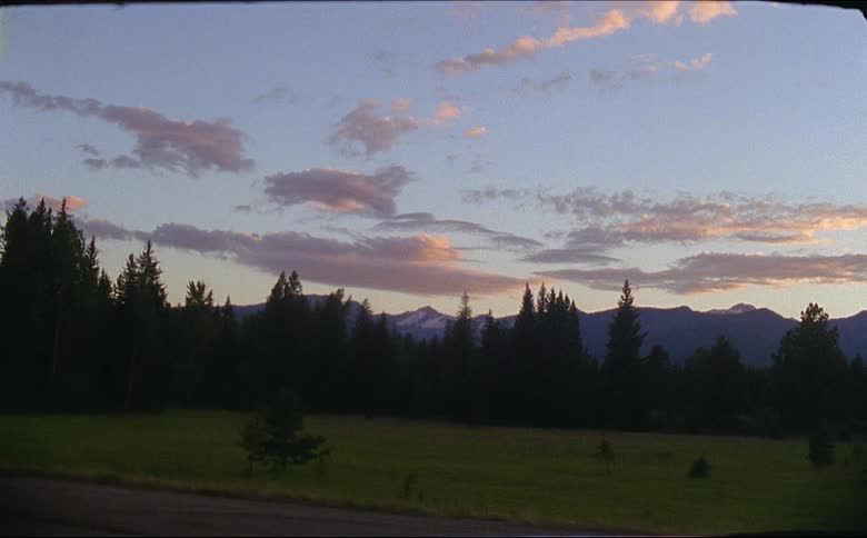 The sun sets in the rocky mountains shot on 16mm flm