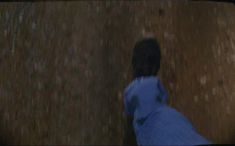 A person in jeans and black shoes hiking outside shot on 16mm film